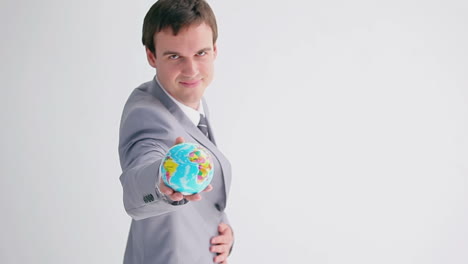 Businessman-showing-a-small-globe