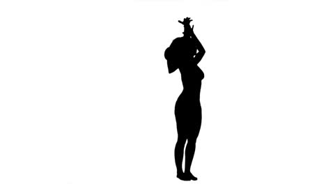 Silhouette-of-a-woman-with-a-hat-on-in-slow-motion