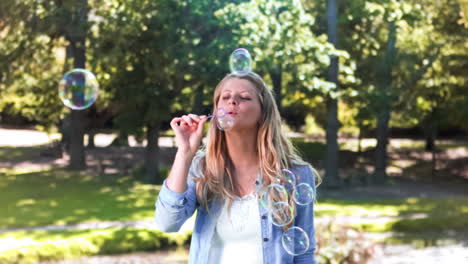 Blonde-woman-in-slow-motion-blowing-bubbles