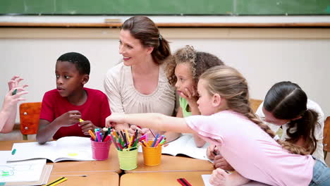 Pupils-and-teacher-sitting-at-a-table