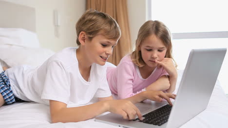 Happy-siblings-using-a-laptop