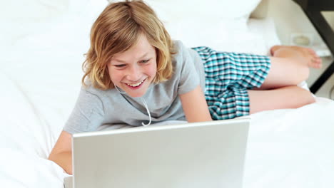 Boy-listening-to-music-on-his-laptop