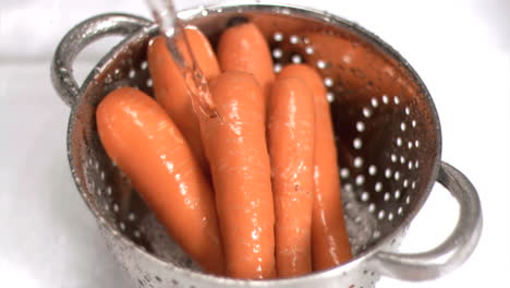 Carrots-being-washed-in-super-slow-motion