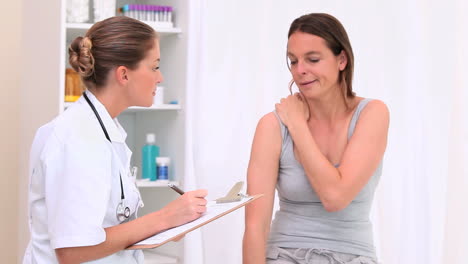 Patient-showing-her-painful-shoulder-to-her-doctor