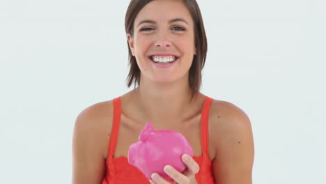 Girl-saving-cash-in-her-piggybank