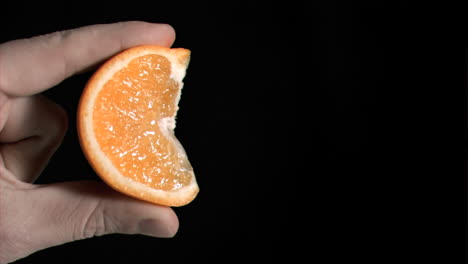 Orange-being-squeezed-in-super-slow-motion