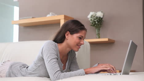 Brunette-haired-woman-typing-on-her-laptop