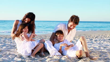 Family-sitting-on-the-sand