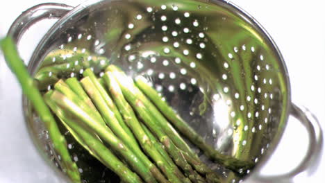 Asparagus-falling-into-sieve-in-super-slow-motion