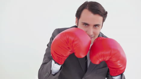 Smiling-executive-boxing-with-red-gloves