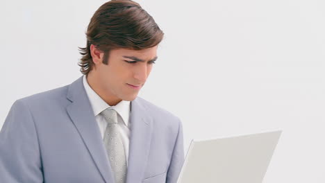 Serious-businessman-holding-his-laptop