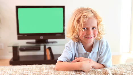 Smiling-boy-sitting-on-the-couch