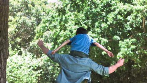 Man-in-slow-motion-holding-his-son-on-his-shoulders