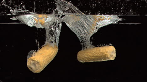 Corn-cobs-dropped-into-water-in-super-slow-motion