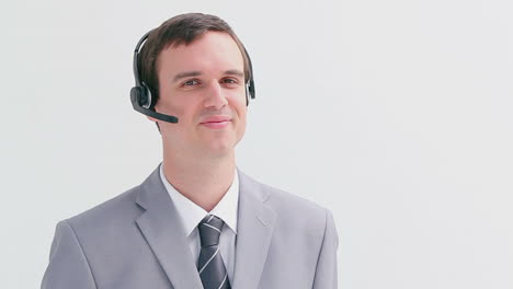 Smiling-call-centre-agent-talking-into-his-headset