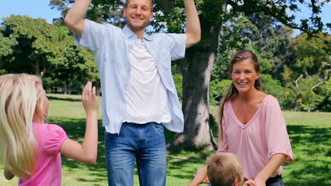 Family-jumping-excitedly-in-the-park