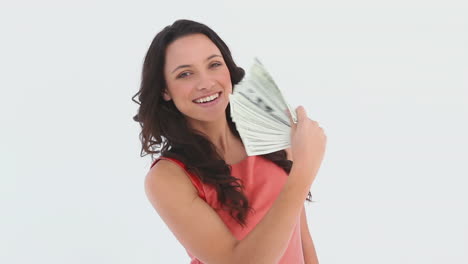 An-attractive-woman-uses-money-notes-as-a-fan