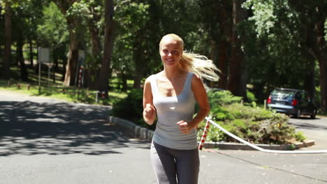 Woman-jogging-down-the-street-as-a-car-drives-behind-her