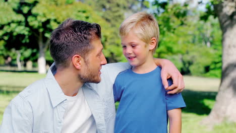 Father-talking-to-his-son-with-his-arm-around-his-shoulder