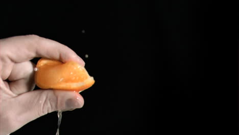 Orange-being-squeezed-in-super-slow-motion