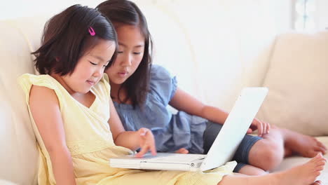 Two-girls-watching-something-on-a-laptop