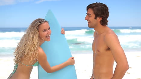 Woman-taking-her-boyfriendss-surfboard