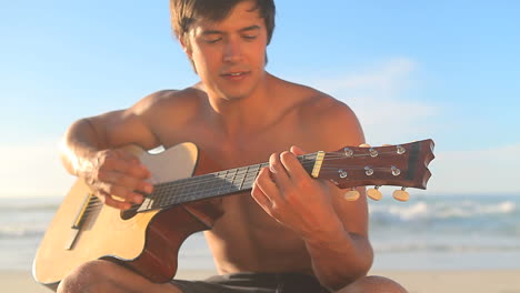 Handsome-man-singing-and-playing-guitar