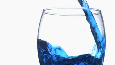 Blue-trickle-in-super-slow-motion-flowing-in-a-glass-