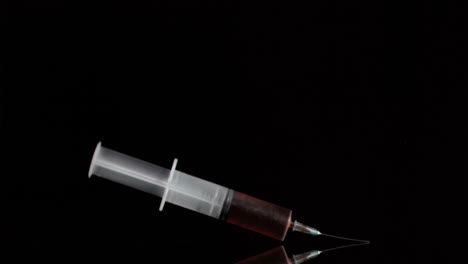 Syringe-in-super-slow-motion-being-filled-by-blood
