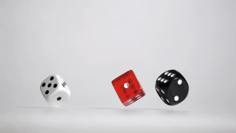 Three-white-red-black-dices-in-a-super-slow-motion-rebonding-