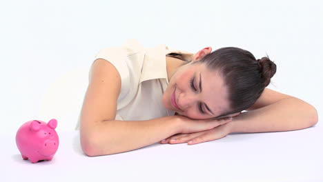 Woman-with-a-piggy-bank-resting-on-a-table