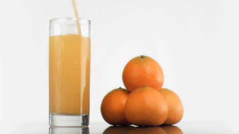 Orange-juice-in-super-slow-motion-filling-a-glass