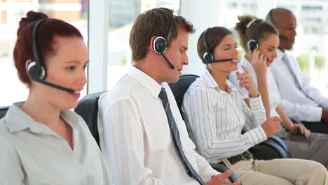 Group-of-business-men-and-women-on-headsets