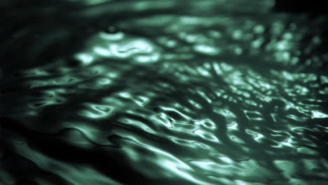 Green-light-in-super-slow-motion-reflecting-in-the-water