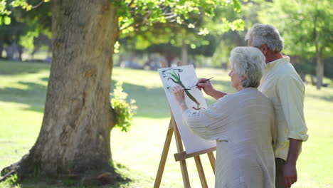 Mature-couple-painting-trees
