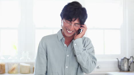 Man-happily-using-a-mobile-phone