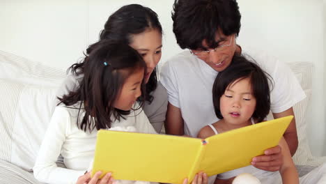 Parents-reading-a-book-to-their-children