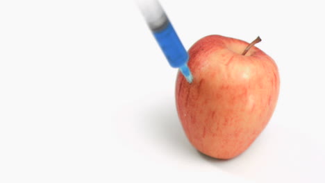 Syringe-in-super-slow-motion-falling-on-an-apple