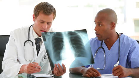 Doctor-and-a-nurse-writing-notes-from-an-xray