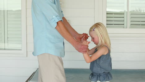 Father-helping-his-daughter-do-a-back-flip