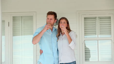 Man-and-a-woman-clinking-glasses-of-champagne-before-holding-each-other