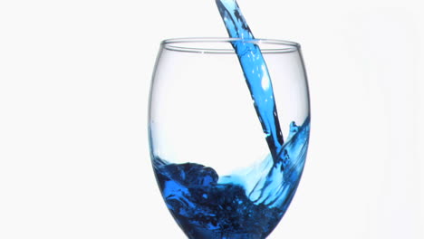 Blue-trickle-in-super-slow-motion-flowing-in-a-wineglass-
