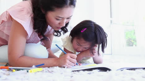 Mother-helping-her-daughter-with-colouring