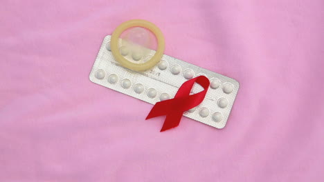 Contraceptive-pill-packet-with-condom-with-red-ribbon