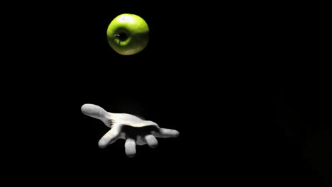 Hand-throwing-a-green-apple-