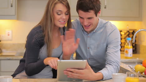 Couple-using-video-chat-on-tablet-pc-