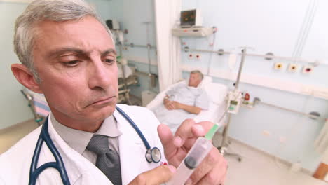 Serious-doctor-with-an-injection-in-his-hands-in-a-room