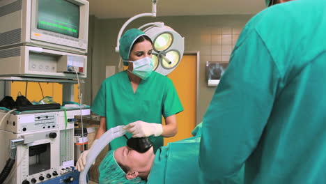 View-of-a-anesthetist-holding-an-mask-while-looking-at-patient