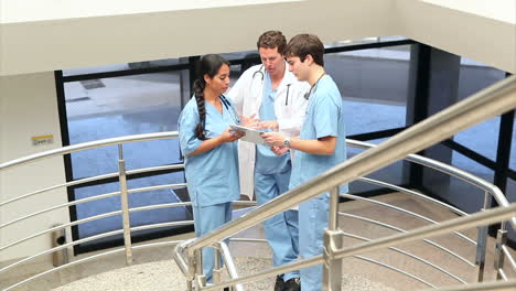 Nurse-holding-a-clipboard-while-looking-it-