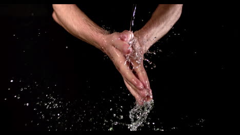 Man-washing-his-hands-under-stream-of-water